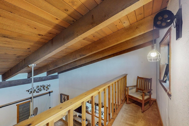 hall featuring carpet floors, lofted ceiling with beams, and wooden ceiling