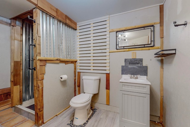 bathroom with vanity, hardwood / wood-style floors, and toilet