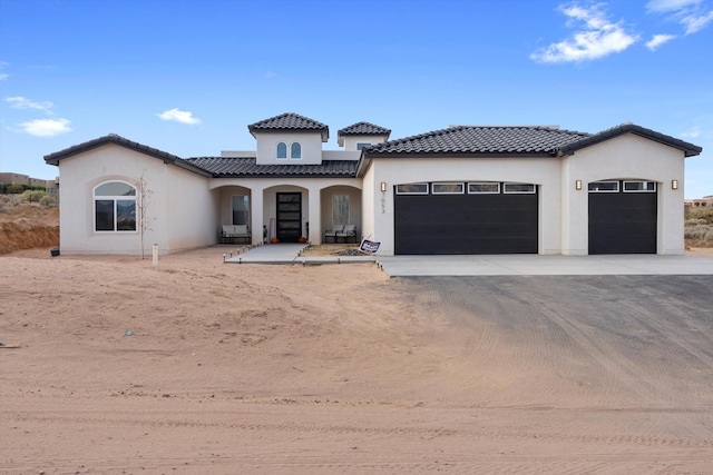 mediterranean / spanish home featuring a garage