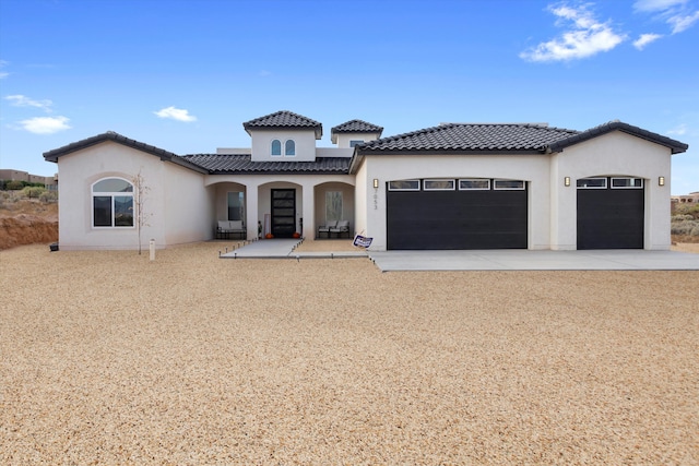 mediterranean / spanish-style house featuring a garage