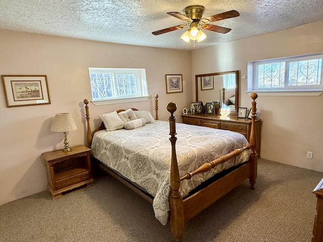 bedroom featuring a textured ceiling, ceiling fan, and carpet flooring