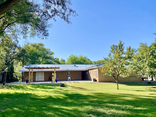 rear view of house with a patio area and a yard