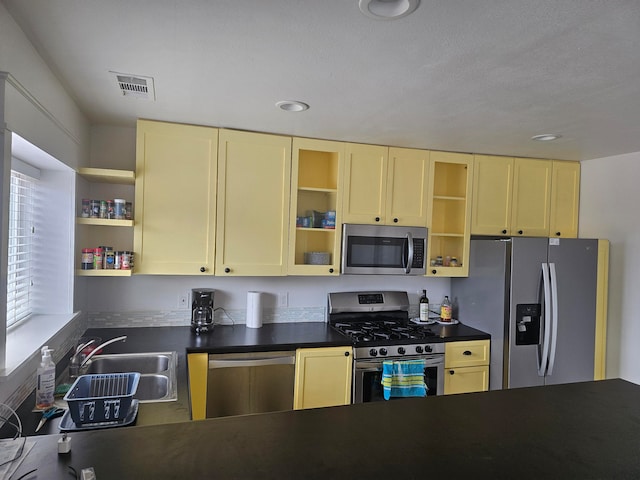 kitchen featuring a textured ceiling, sink, and stainless steel appliances