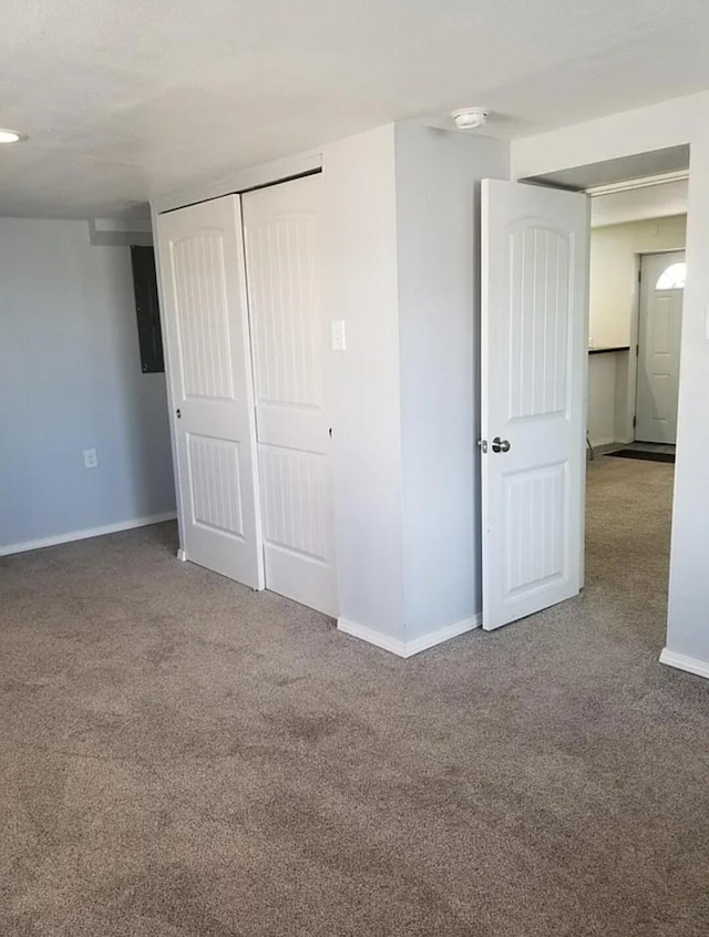 unfurnished bedroom featuring carpet and a closet