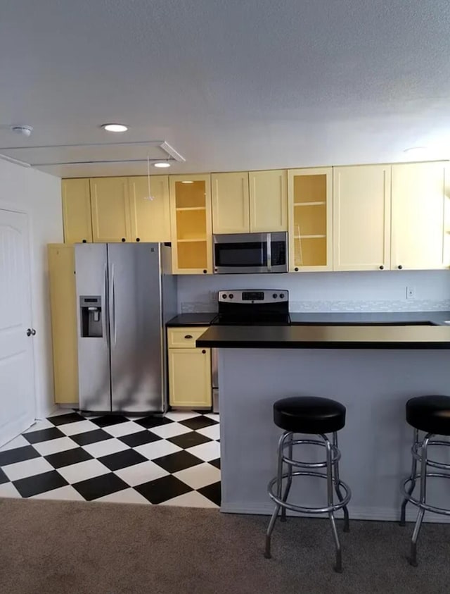 kitchen with stainless steel appliances and a breakfast bar