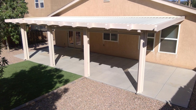 rear view of property with a patio and a pergola