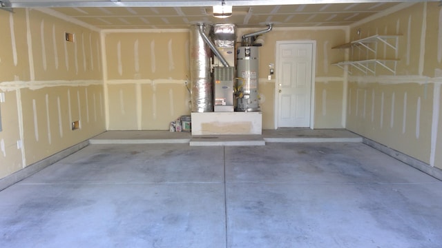 garage featuring water heater and heating unit