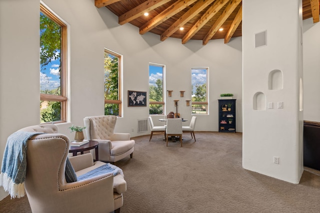 sitting room with beam ceiling, carpet flooring, high vaulted ceiling, and wooden ceiling