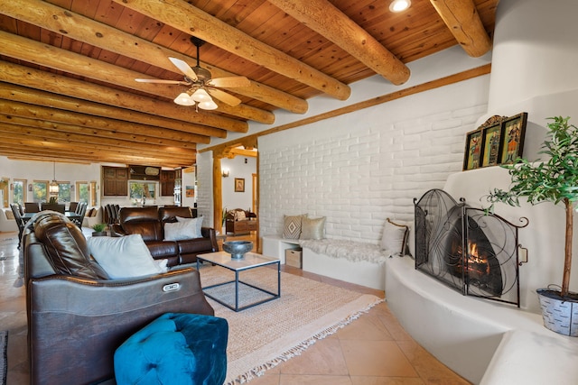 tiled living room with brick wall, beamed ceiling, wood ceiling, and ceiling fan