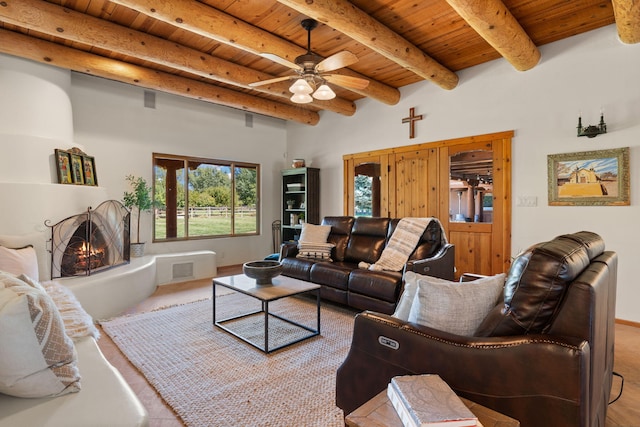 living room with ceiling fan, wood ceiling, and beam ceiling