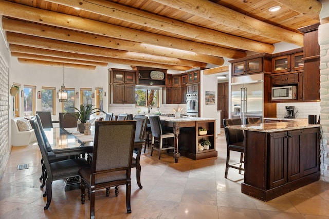 dining room with light tile patterned floors, beam ceiling, and wooden ceiling