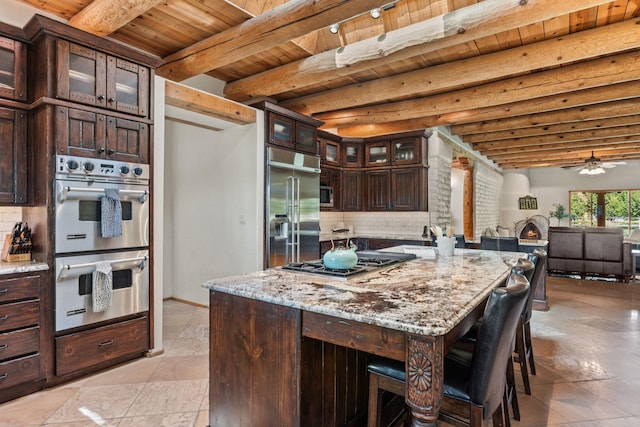 kitchen with wood ceiling, tasteful backsplash, light stone countertops, beamed ceiling, and stainless steel appliances