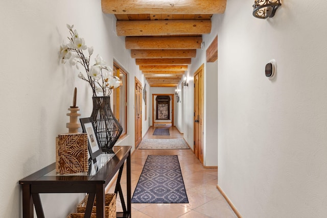 hall with beam ceiling and light tile patterned flooring