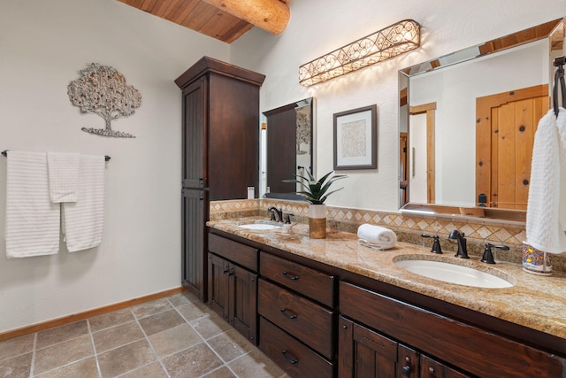 bathroom featuring wooden ceiling, decorative backsplash, vanity, and vaulted ceiling with beams