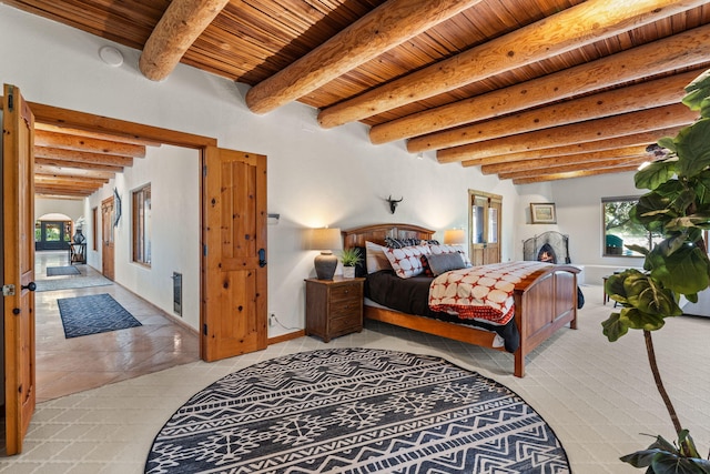 bedroom with wood ceiling, beam ceiling, and light tile patterned flooring