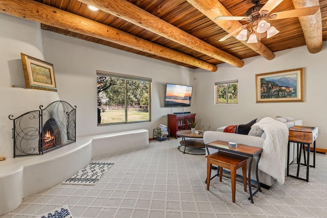 carpeted living room featuring ceiling fan, beamed ceiling, and wood ceiling