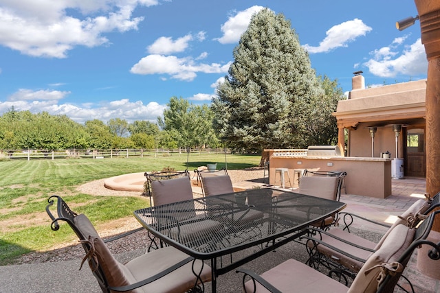 view of patio / terrace featuring a rural view and an outdoor kitchen