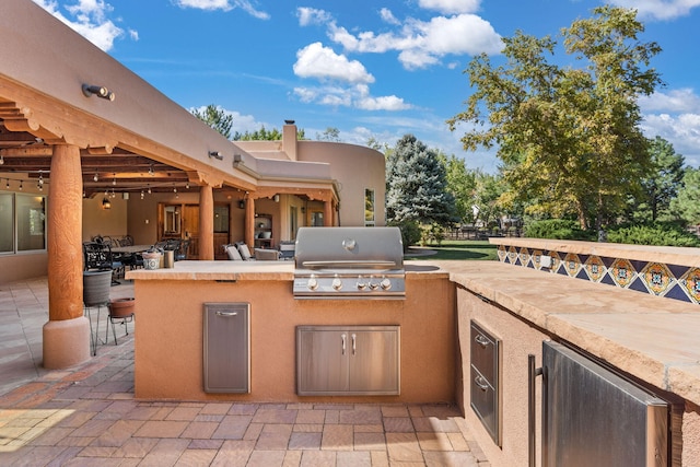 view of patio featuring a bar, area for grilling, and a grill