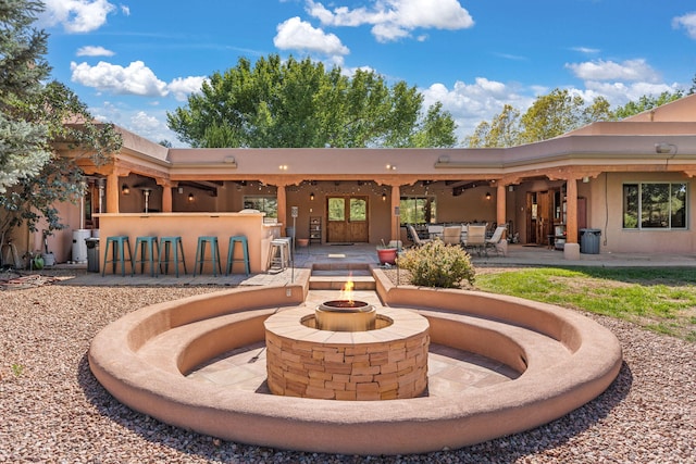 back of house featuring a fire pit and a patio area