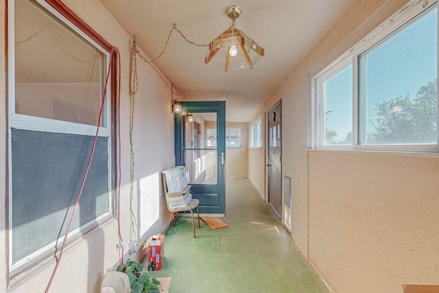 hall featuring concrete flooring