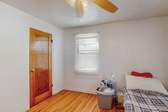 bedroom with ceiling fan and light hardwood / wood-style flooring