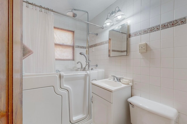 bathroom featuring tile walls, toilet, vanity, and a shower with shower curtain