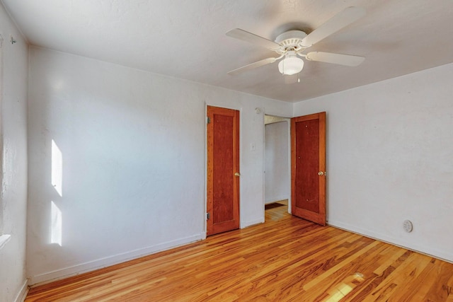 spare room featuring light hardwood / wood-style floors and ceiling fan