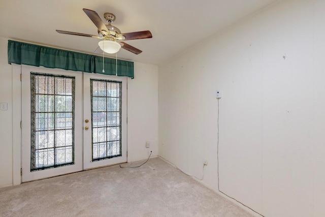 carpeted spare room with french doors and ceiling fan