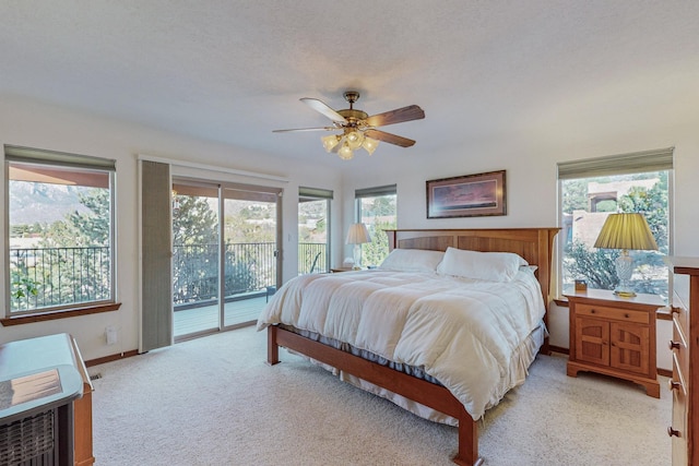 bedroom with ceiling fan, light colored carpet, a textured ceiling, and access to outside