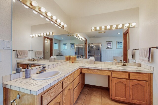 bathroom with tile patterned floors, an enclosed shower, and vanity