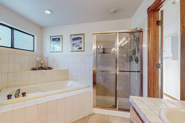 bathroom with a shower with door, vanity, and tile patterned floors