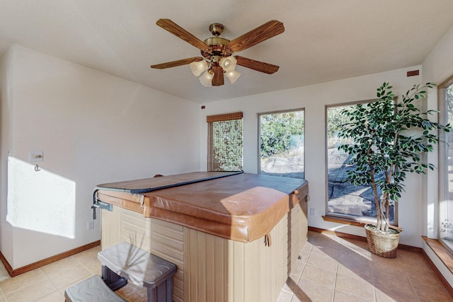 interior space with light tile patterned flooring and ceiling fan