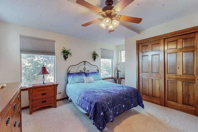 bedroom with ceiling fan and light carpet