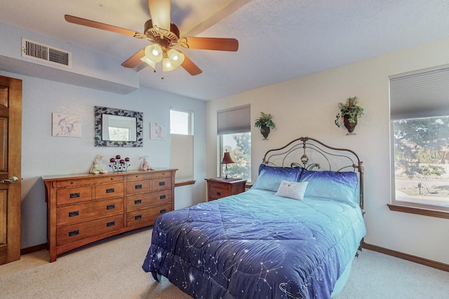 carpeted bedroom with a textured ceiling and ceiling fan