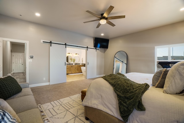 bedroom featuring baseboards, a barn door, recessed lighting, and light colored carpet