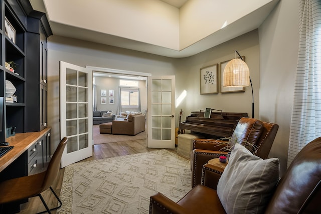 sitting room with french doors and light wood finished floors