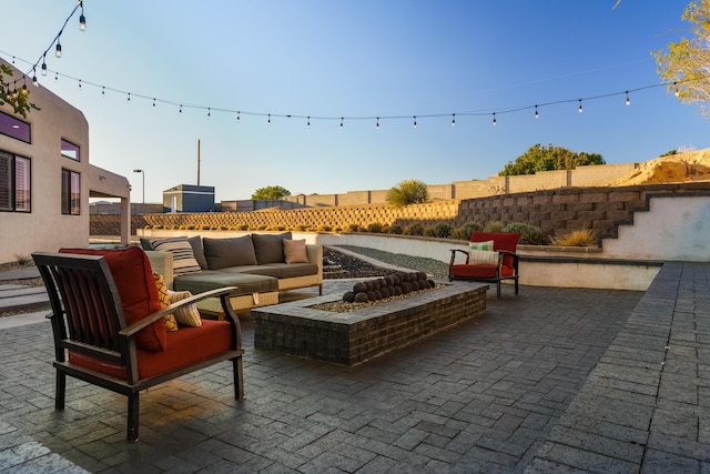 view of patio featuring a fenced backyard and an outdoor living space with a fire pit