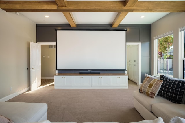 home theater room featuring beam ceiling, recessed lighting, light colored carpet, visible vents, and baseboards