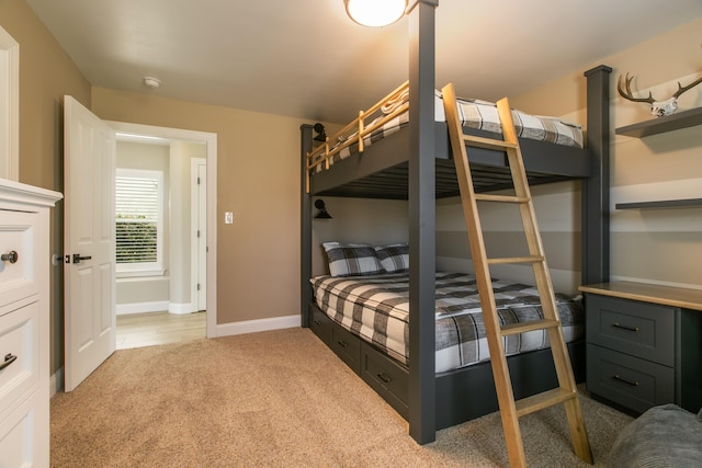 bedroom featuring carpet flooring and baseboards