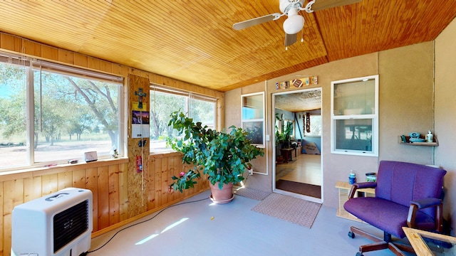 sunroom with ceiling fan, heating unit, wood ceiling, and lofted ceiling