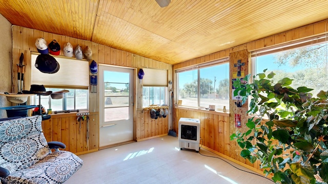 sunroom with heating unit, vaulted ceiling, and wooden ceiling