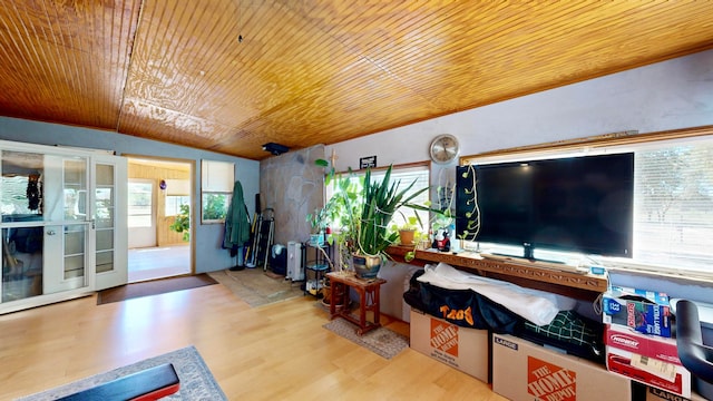 living room featuring wooden ceiling, light hardwood / wood-style floors, vaulted ceiling, and plenty of natural light