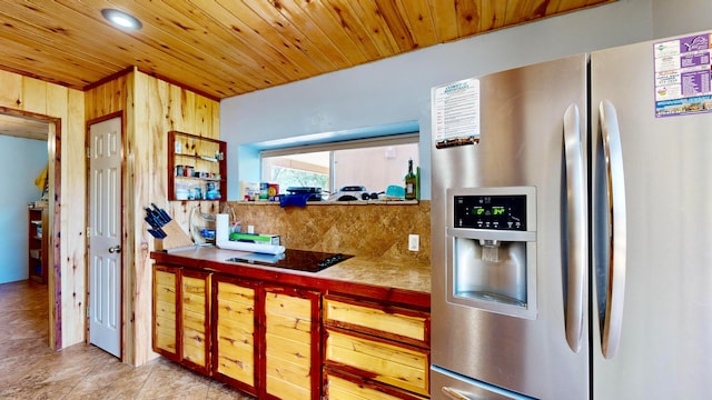 kitchen with decorative backsplash, wood ceiling, stainless steel fridge with ice dispenser, and wooden walls