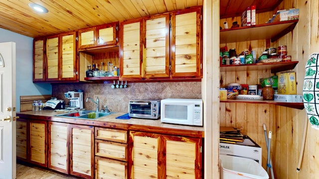 kitchen featuring wood ceiling, sink, and tasteful backsplash