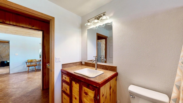 bathroom featuring tile patterned floors, vanity, and toilet