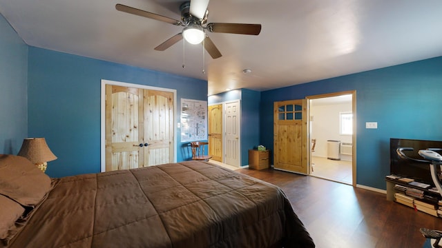 bedroom with ensuite bath, ceiling fan, and dark hardwood / wood-style flooring