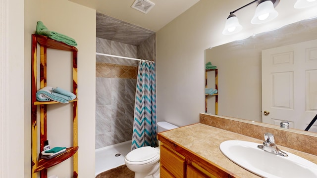 bathroom with curtained shower, vanity, and toilet