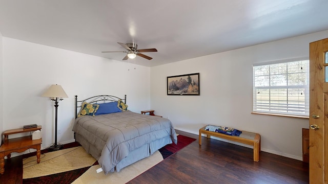 bedroom with ceiling fan and dark wood-type flooring