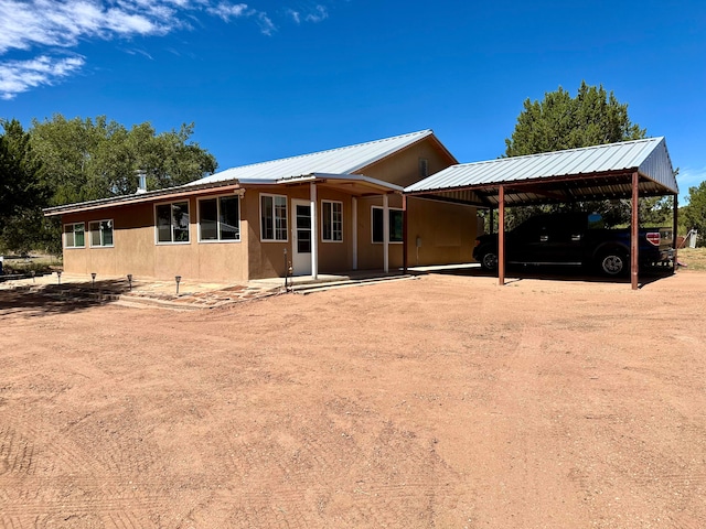 rear view of house featuring a carport