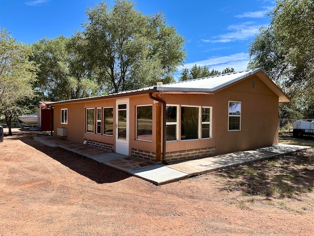 back of property featuring a patio